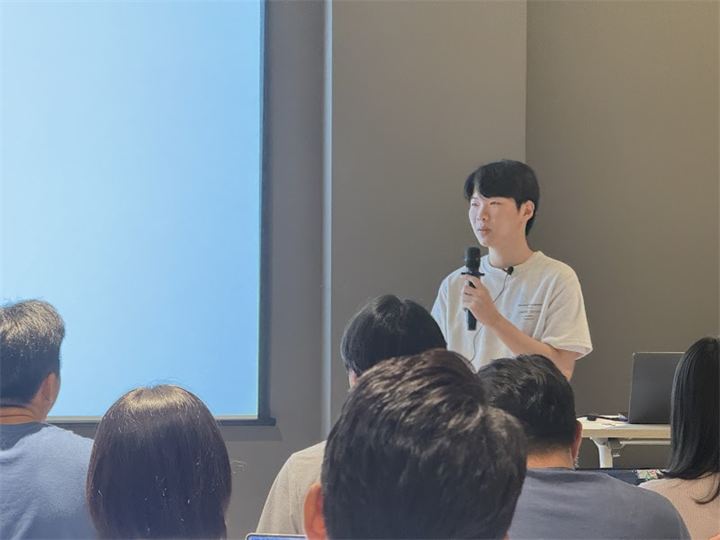 마이크를 들고 발표하는 연사
